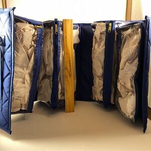 Never used Joy Mangano Large Roll up beauty/toiletries/accessories case.